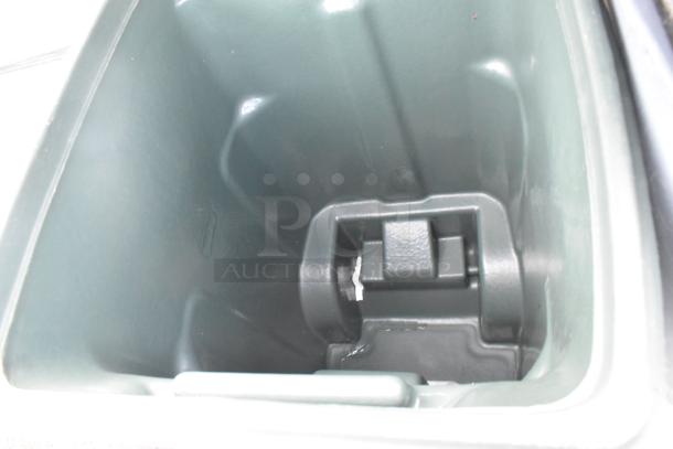 Interior view of a grey poly trash can, showing its smooth, clean surface and sturdy construction. No tags visible.