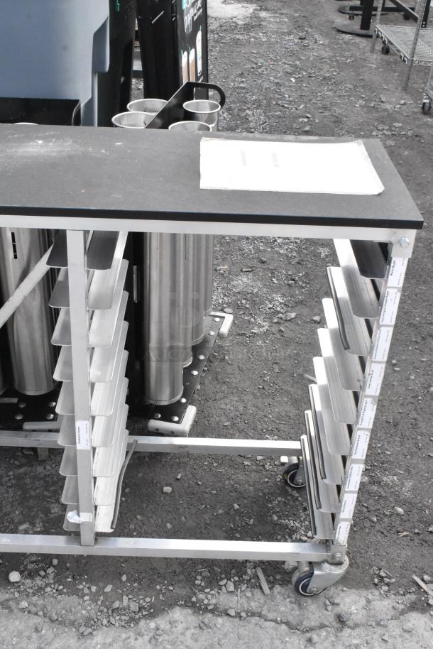 Metal commercial double pan rack on casters, features multiple pan slots, sturdy construction, suitable for kitchen use.