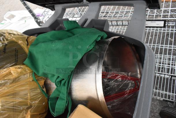 Two gray poly trash cans with baskets, green fabric, and floor mats. Auction item includes contents.