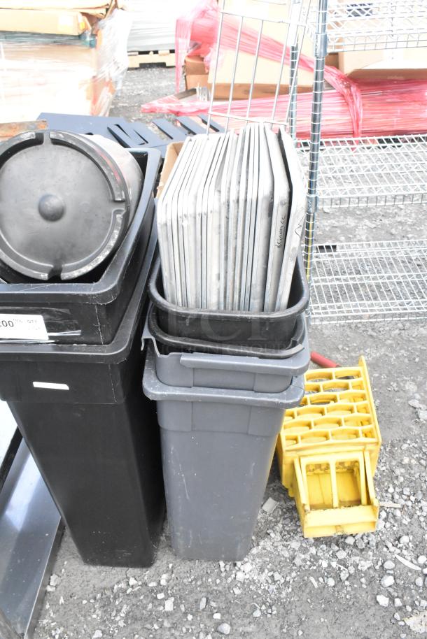 Lot of items including black and gray Poly Slim Jim trash cans, metal pans, and a yellow crate; suitable for storage.