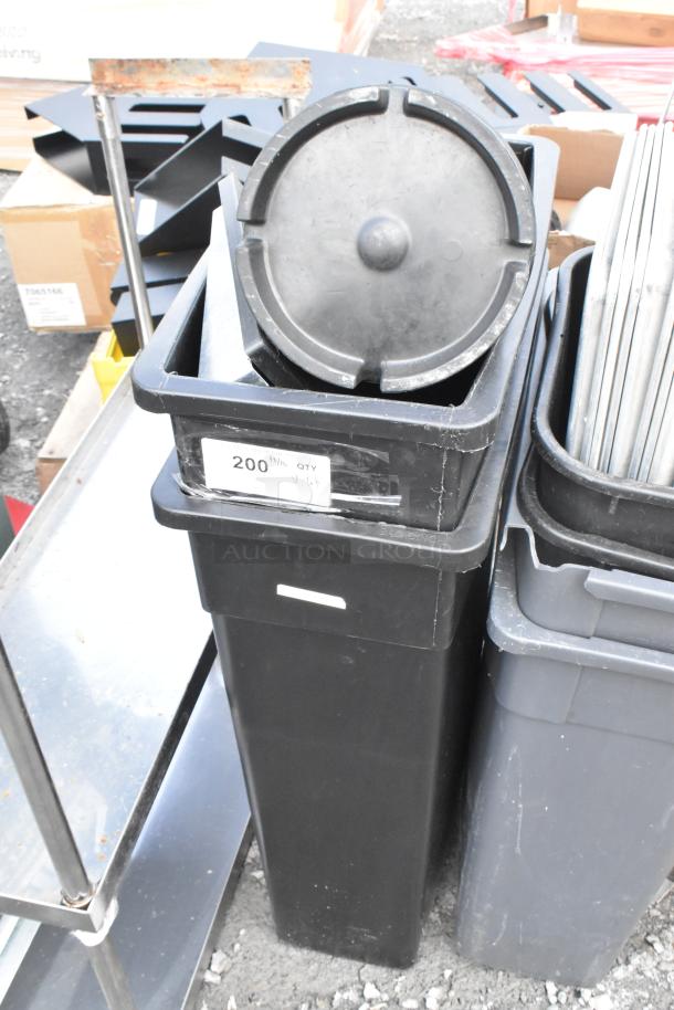 Lot with Poly Slim Jim trash cans, black metal pans. Visible label: "200 QTY". Items in used condition.