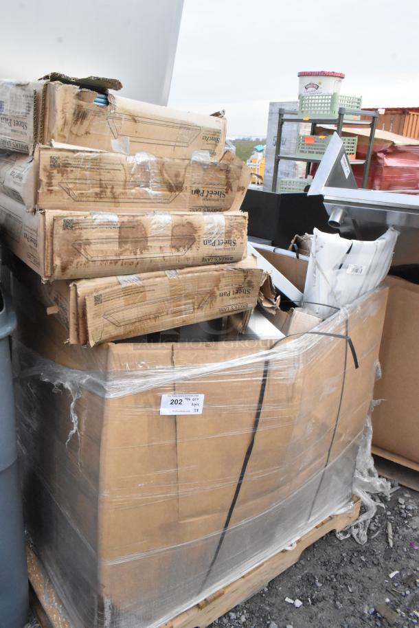 Boxed items including new metal baking pans, chair frame, table in scratch and dent condition on pallet, labeled "Lot 202".