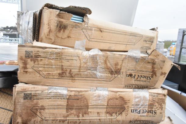 Boxes of 8 brand new scratch and dent items, including metal baking pans, showing wear and tear on cardboard packaging.