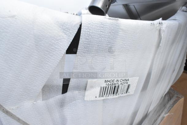 Scratch and dent item with "Made in China" label, barcode, and packaging damage. Includes metal baking pans, chair frame, table.