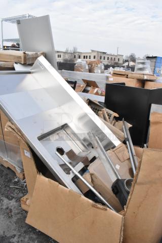 5 Brand New Scratch and Dent items, including a Regency work table and baking pans, in packaging.