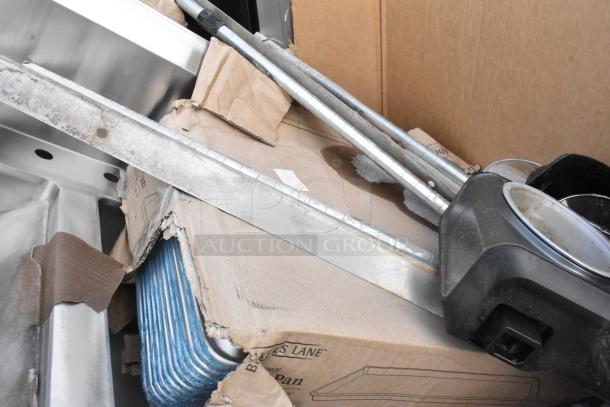 New Regency work table, baking pans, and additional items in box. Items include visible scratches and dents.