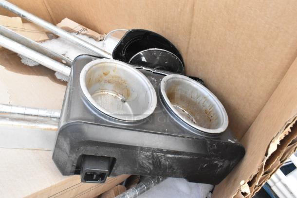 Assorted kitchenware including baking pans and a Regency work table, scratch and dent condition, in a cardboard box.