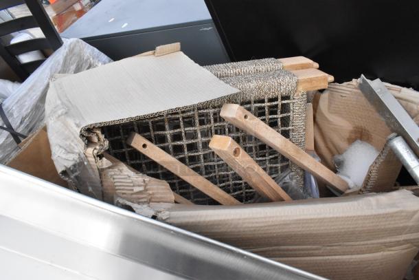 5 brand new scratch and dent items; includes Regency work table, baking pans. Packed in cardboard. Sale as-is.