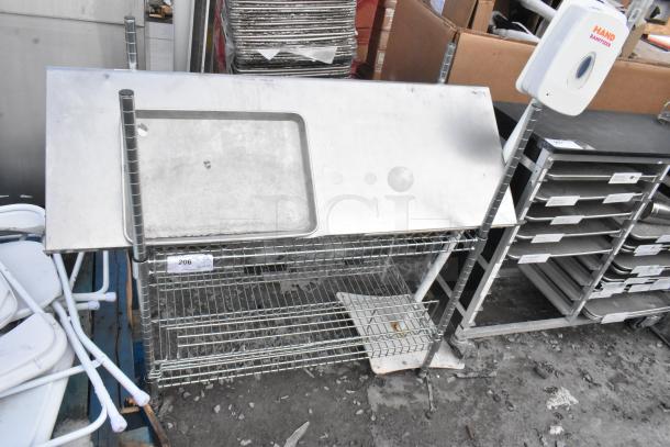Chrome finish 2 tier wire shelving unit with top shelf. Good condition. Buyer must dismantle. Consider freight charges.