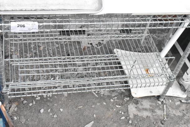 Chrome finish 2-tier wire shelving unit; sturdy metal construction. Note: buyer must dismantle for shipping; see label #206.