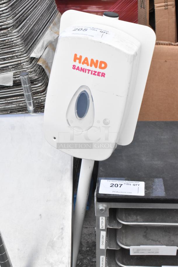 Hand sanitizer dispenser on stand, white, labeled "HAND SANITIZER," includes window for level visibility, appears in good condition.
