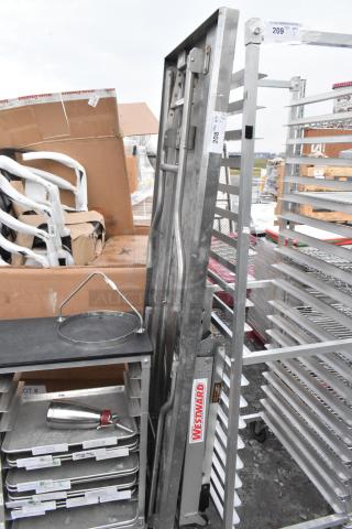 Metal folding table and Westward ladder attachment. Items are in used condition with visible labels and markings.