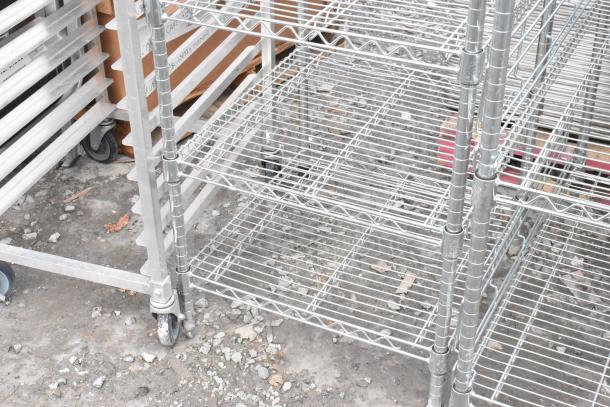 Chrome finish 6-tier wire shelving unit, sturdy design, on wheels for mobility, slight wear, buyer dismantles for shipping.