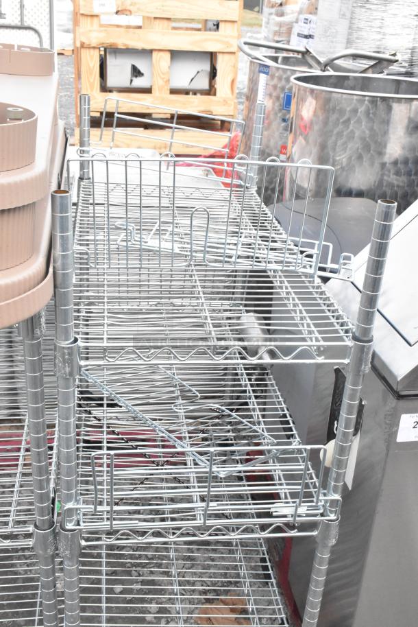 Two chrome wire shelving units in good condition. Features multiple tiers and adjustable shelves. Buyer must dismantle.