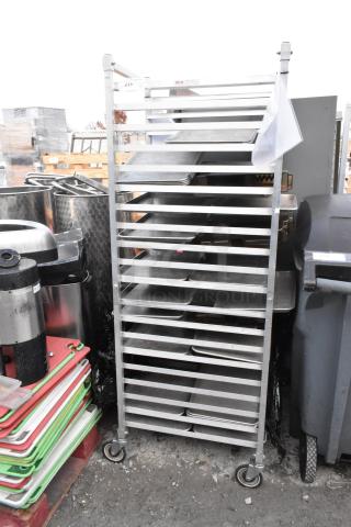 Metal pan transport rack with commercial casters, sturdy construction, multiple shelves, good condition.
