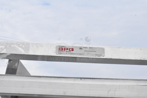 Metal pan transport rack by Kelmax SPG with model number 4H7133. Features commercial casters for mobility.