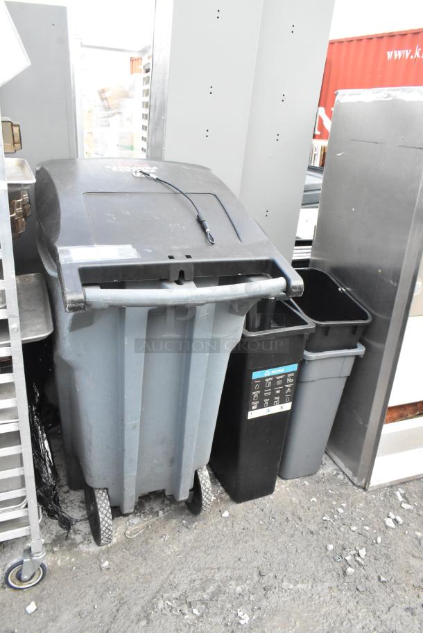Four various trash cans including a Rubbermaid Slim Jim and a large wheeled bin, in used condition with visible labels.