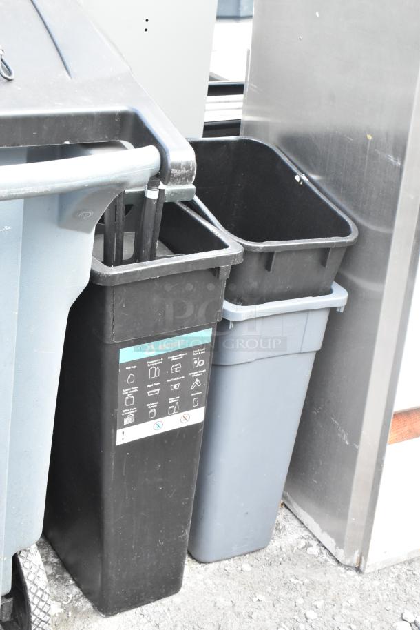 Set of four trash cans including Slim Jim, various styles and colors, used condition. Recycle label on one can.