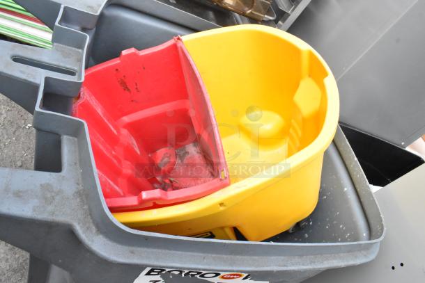 Four assorted trash cans including Slim Jim, varying colors and conditions, stacked; label indicates auction item.