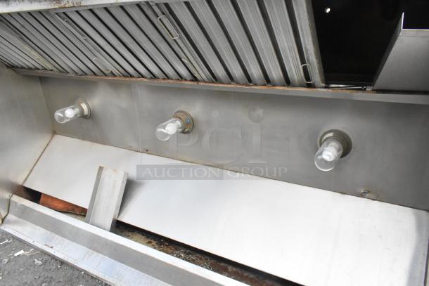 8' metal commercial grease hood with filters and lights, stainless steel finish, visible signs of use, suitable for restaurants.