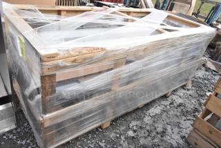 Brand new Regency 600S31824218 stainless steel 3 bay sink with dual drain boards, no legs, partially wrapped on a pallet.