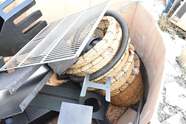 Pallet lot of various items, including metal grid, thick rope, and plastic lid dispenser. Mixed condition.