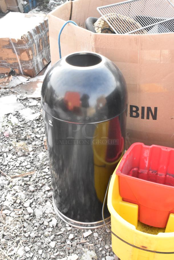 Four items: black metal trash can shell, two Slim Jim trash cans, and a mop bucket. Sold as a lot. Visible in used condition.