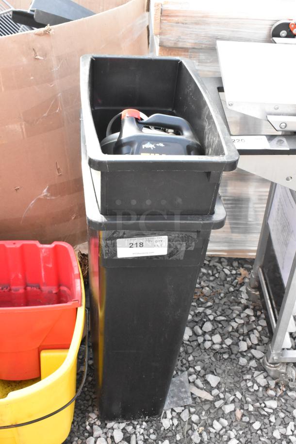 Black Slim Jim trash can, yellow mop bucket, black metal trash can shell, red mop wringer. Note label: "218."