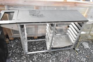Metal commercial double pan transport rack with commercial casters, used condition, visible wear on top surface.