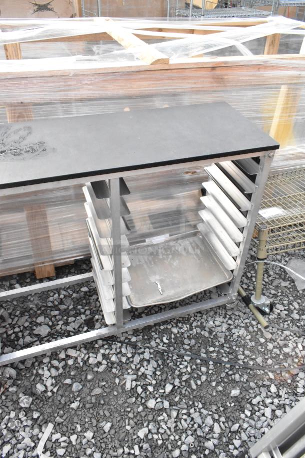 Metal commercial double pan transport rack with multiple slots, commercial casters, and a sturdy frame. Slight wear visible.