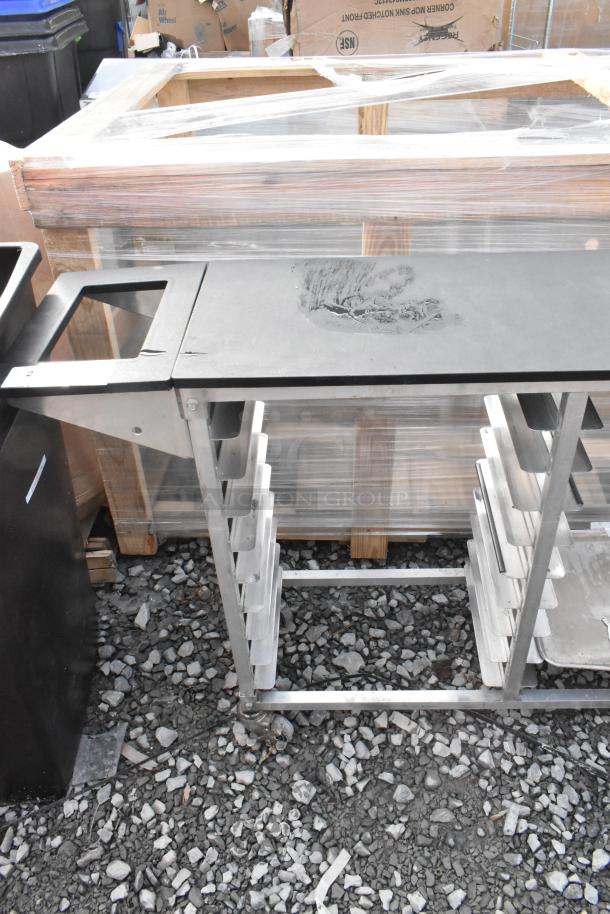 Metal commercial double pan transport rack with commercial casters, showing minor wear. Ideal for kitchen logistics.