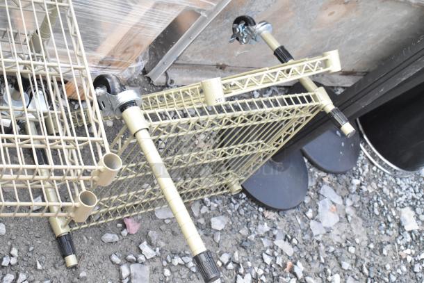 Two tan, 2-tier wire shelving units with wheels, dismantled. Buyer must dismantle for shipping. Consider freight charges.