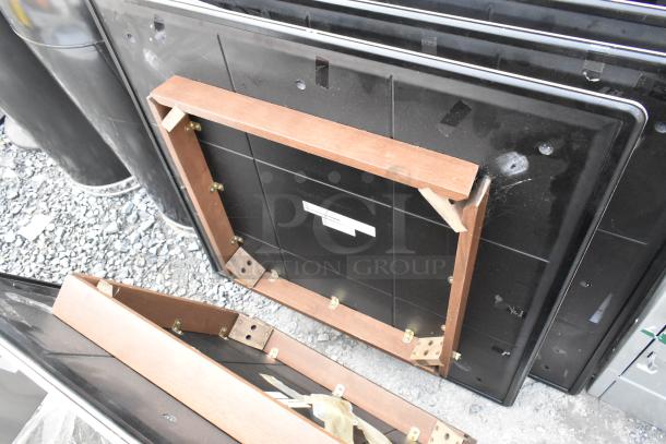 Five assorted tabletops stacked, featuring wooden frames and metal hardware. Various sizes, good condition. Ideal for custom use.