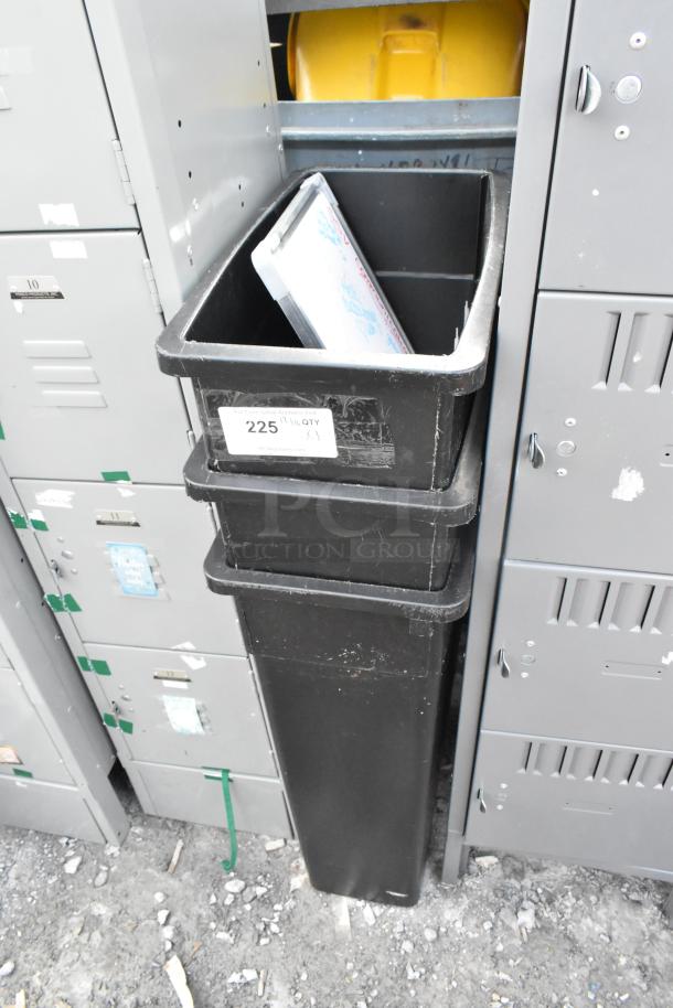 Three black Poly Slim Jim trash cans in used condition, stacked vertically. Label indicates "225, qty 3".