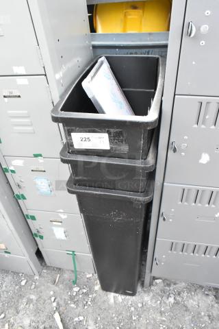 Three black Poly Slim Jim trash cans in used condition, stacked vertically. Label indicates "225, qty 3".