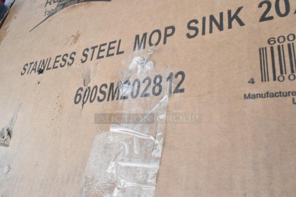Close-up of a cardboard box labeled "Stainless Steel Mop Sink" and model "600SM202812," part of an auction lot.