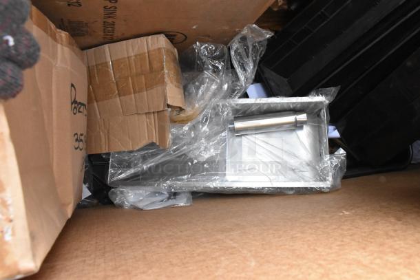 Stainless steel floor mop sink 33" new, in packaging. Includes cardboard boxes. Regency model 600SM202812 visible.