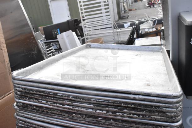 Stack of 95 metal full-size baking pans, used condition, slight discoloration, ideal for bulk purchase at auction.