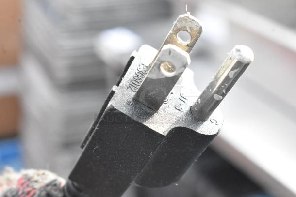 Close-up of power plug for Avantco 177BMFW5 bain marie, showing prongs and label.