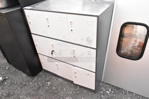 9 cubby locker with metal frame and white doors, some wear and scratches visible. One door has a key lock.