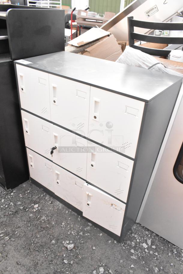 9 cubby locker with white doors, minor surface wear, single lock, ventilation holes, and label slots.