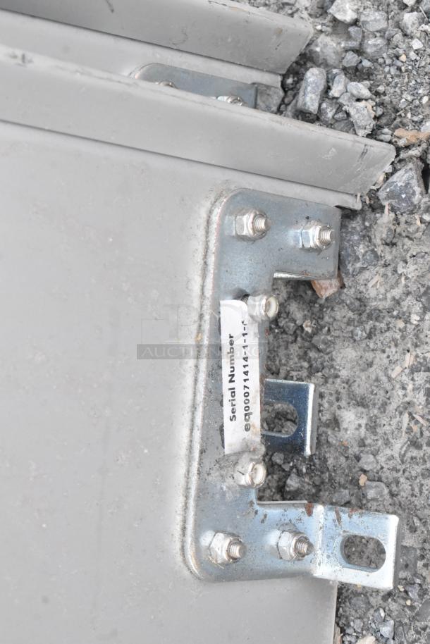 Two metal swinging kitchen doors with visible bolts and a label showing the serial number "eq00071414-1". Used condition.