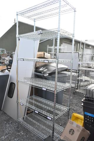 Chrome finish 6 tier wire shelving unit in outdoor setting, undismantled. Buyer must dismantle. Consider freight charges.