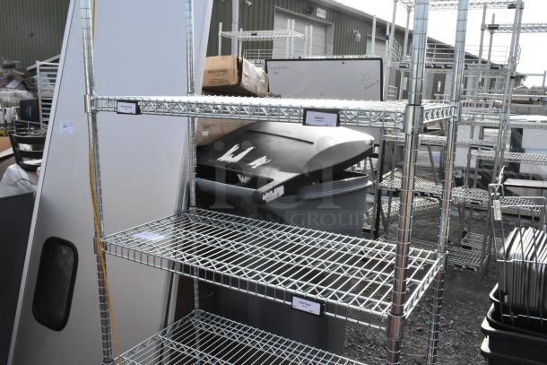 Chrome finish 6-tier wire shelving unit, visible labels indicating sections, sturdy metal construction, in good condition.
