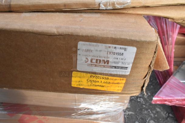 Boxes of brand new scratch and dent items including Metro and Cambro shelving units. Labels show part number and carton info.