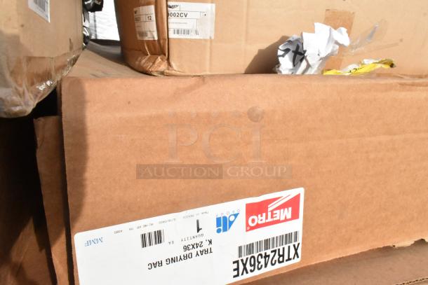 Boxes containing 20 brand new scratch and dent items, including MetroMax Q shelf, wall mounted shelving, and Vollrath pan cover; labels visible.