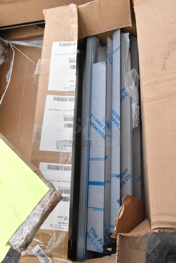 12 new scratch and dent items, including Focus FF2436G epoxy wire shelf, John Boos EPP-74-G post. Visible packaging labels.