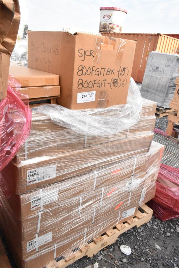 Stack of brand new Eagle Group T2436B work tables and Metro MLD1 pan carrier dolly. Labeled boxes, wrapped on pallets.