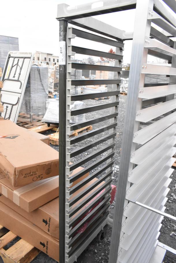 Metal commercial pan transport rack with multiple slots, on sturdy casters, in excellent condition.