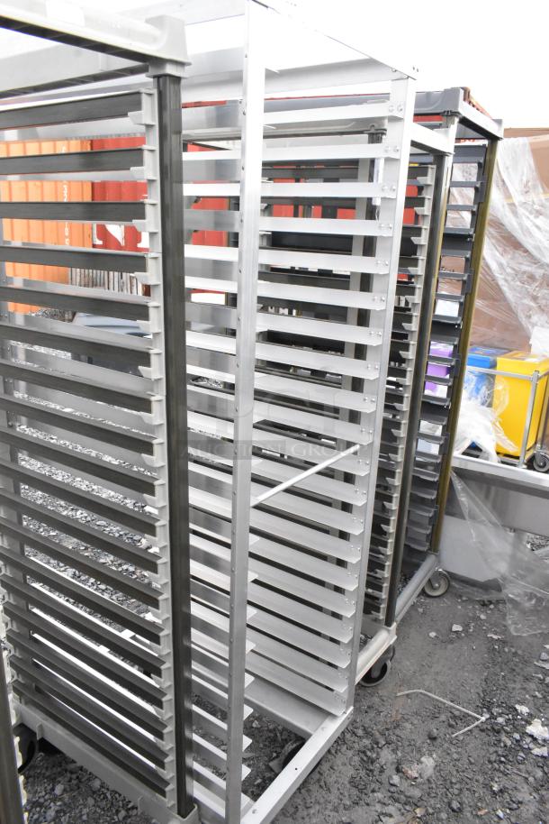 Metal commercial pan transport rack with multiple shelves on sturdy casters. Good condition, ideal for kitchen use.